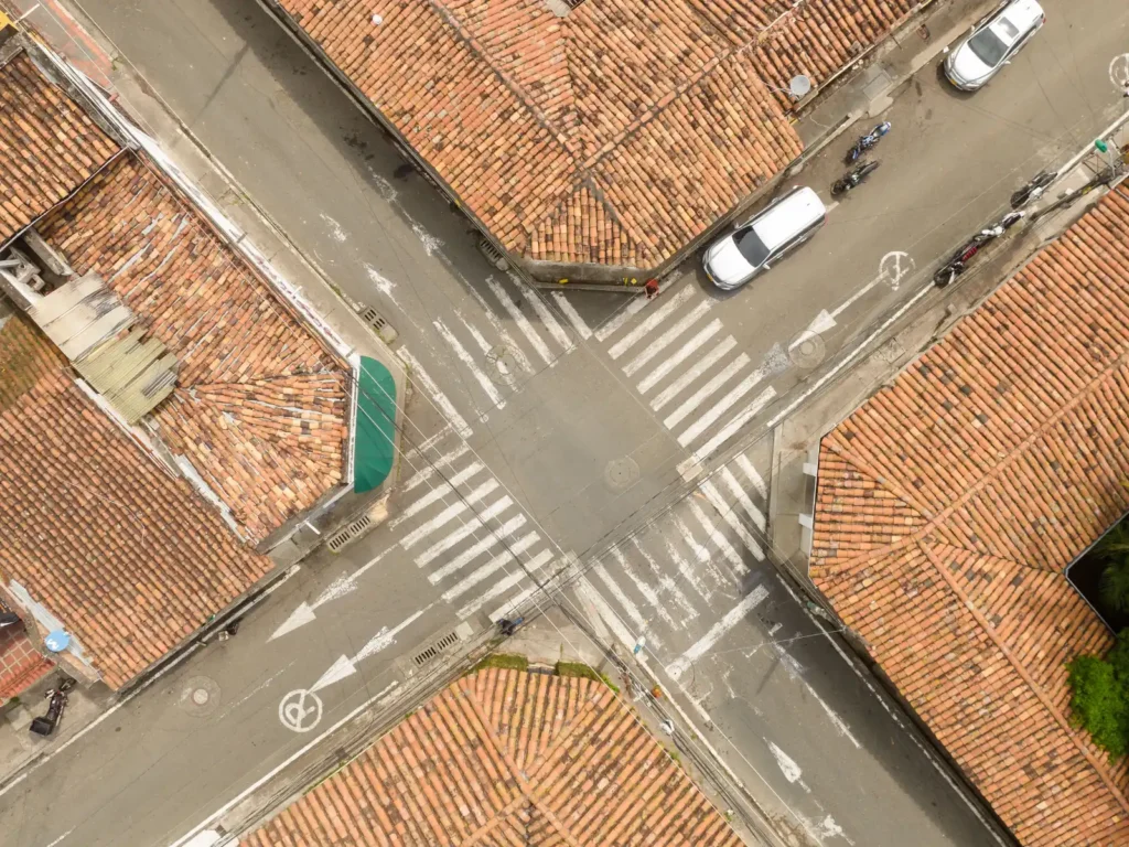 Gay-Couples-therapy-in-Los-Angeles Aerial view of an intersection with terracotta rooftops and crosswalks, symbolizing different paths converging. Represents the journey of gay couples therapy in Los Angeles, where individuals come together to strengthen their
