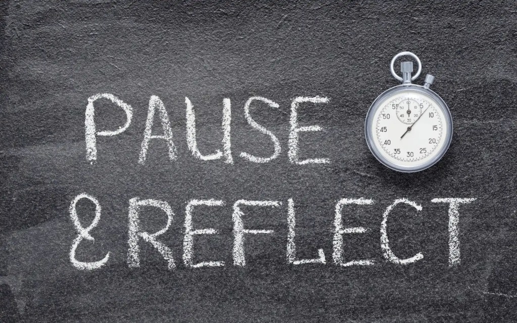 Interracial-couples-therapy-racial-biases The words "Pause and Reflect" written on a chalkboard, representing the importance of reflecting on your own racial biases