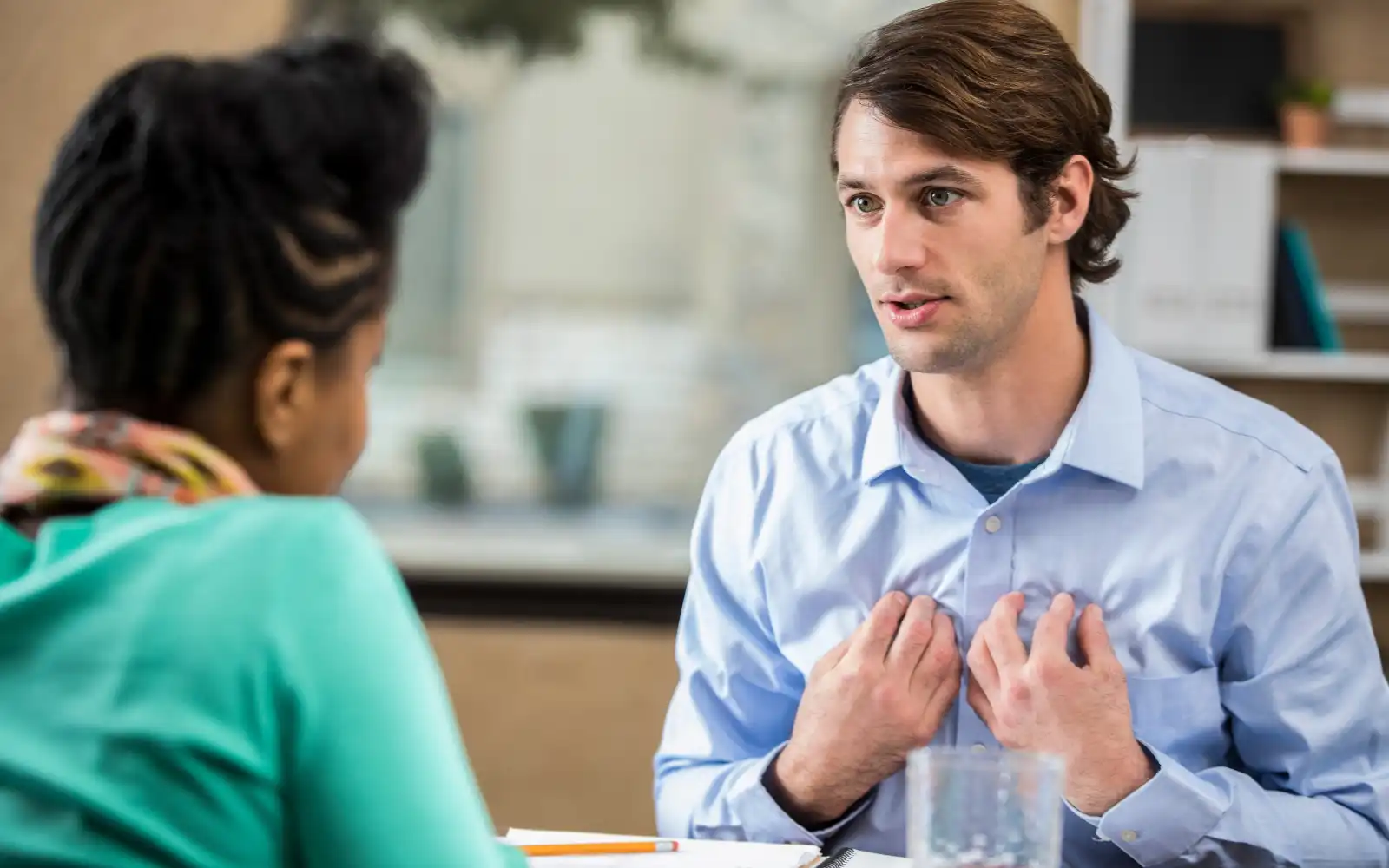An interracial couple having in-depth, emotionally vulnerable conversations in their kitchen after EFT therapy