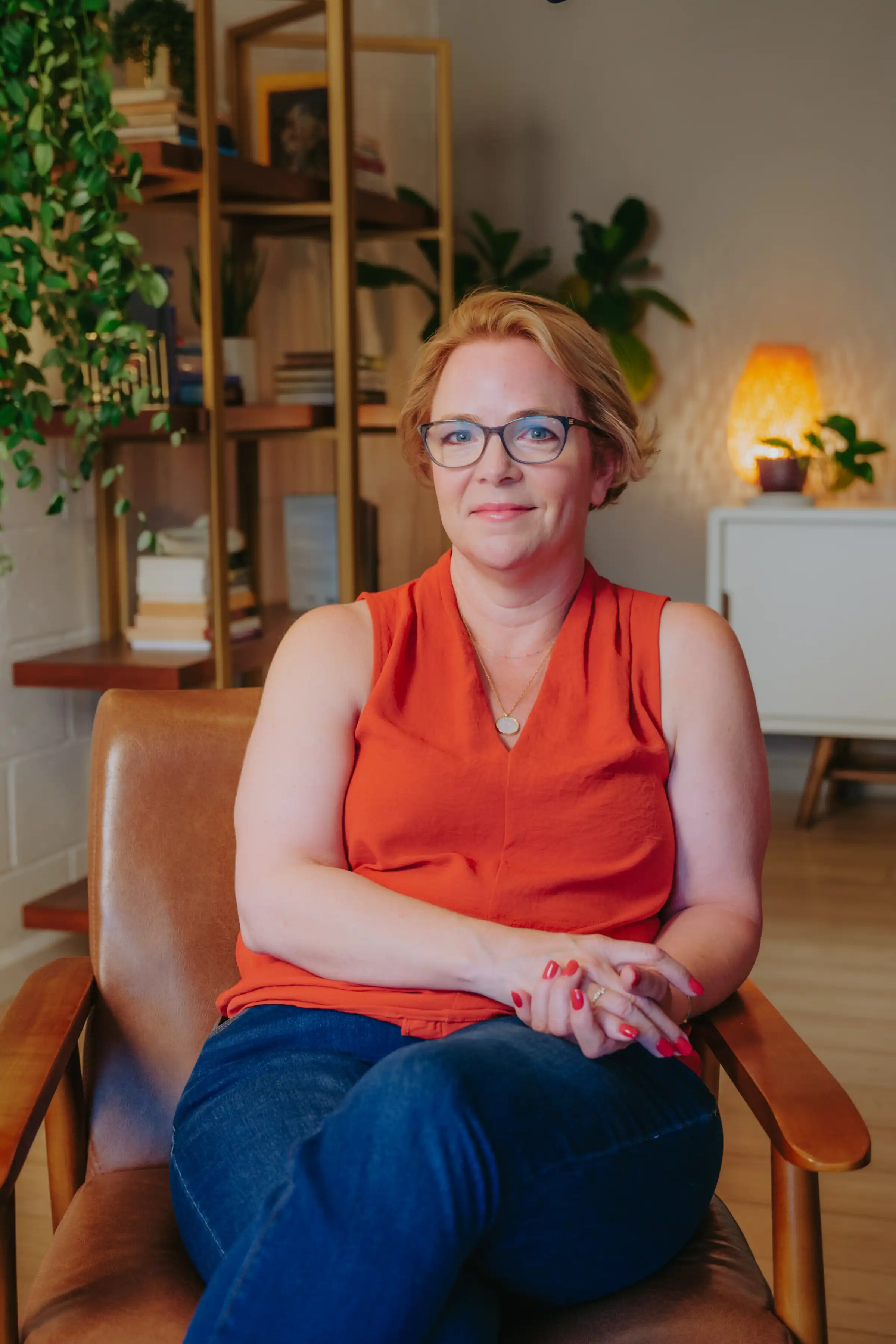 Samantha Lam standing and smiling at the camera in her office at GGPA