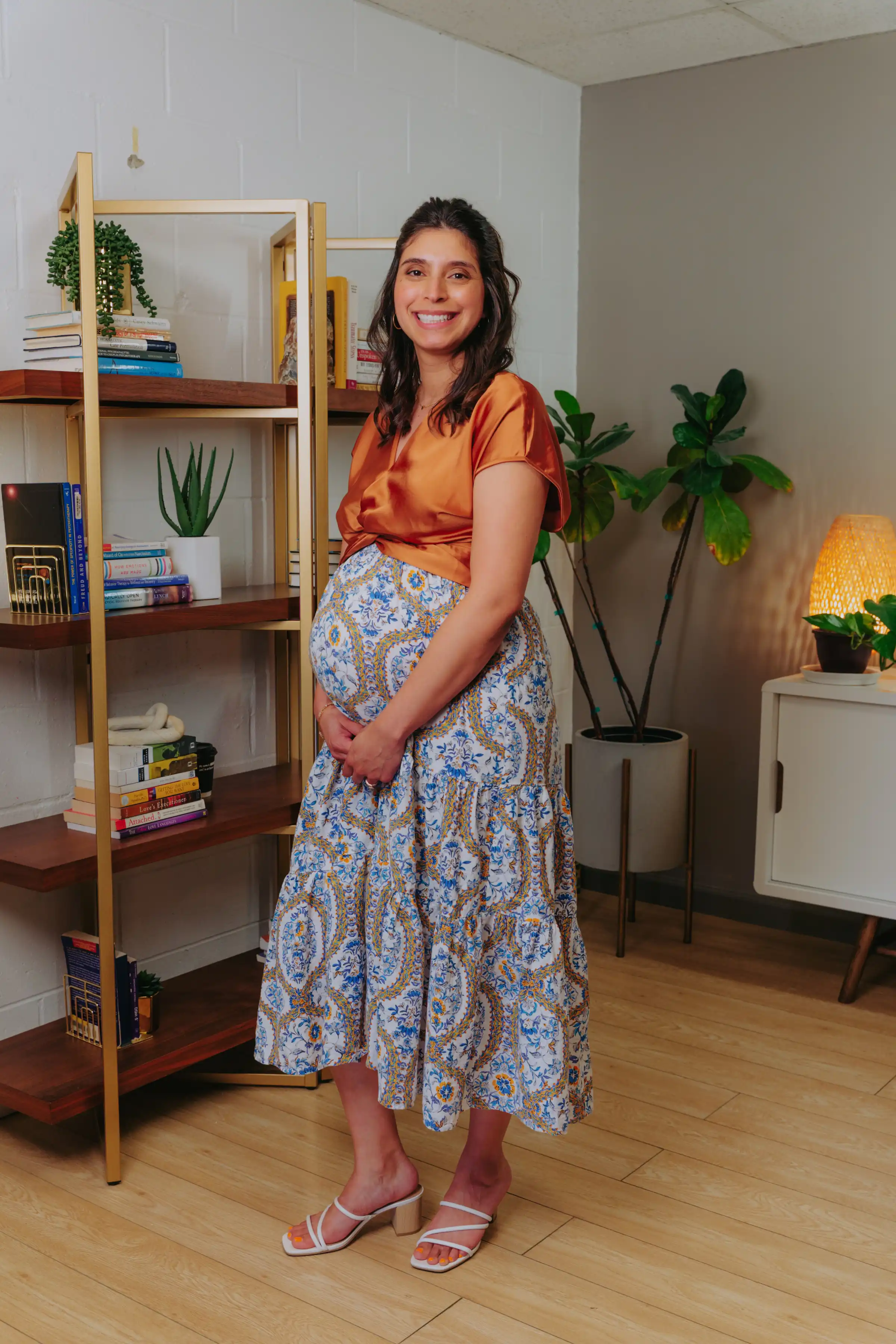 Tiffany Cuevas standing and smiling in her office at Grazel Garcia Psychotherapy & Associates