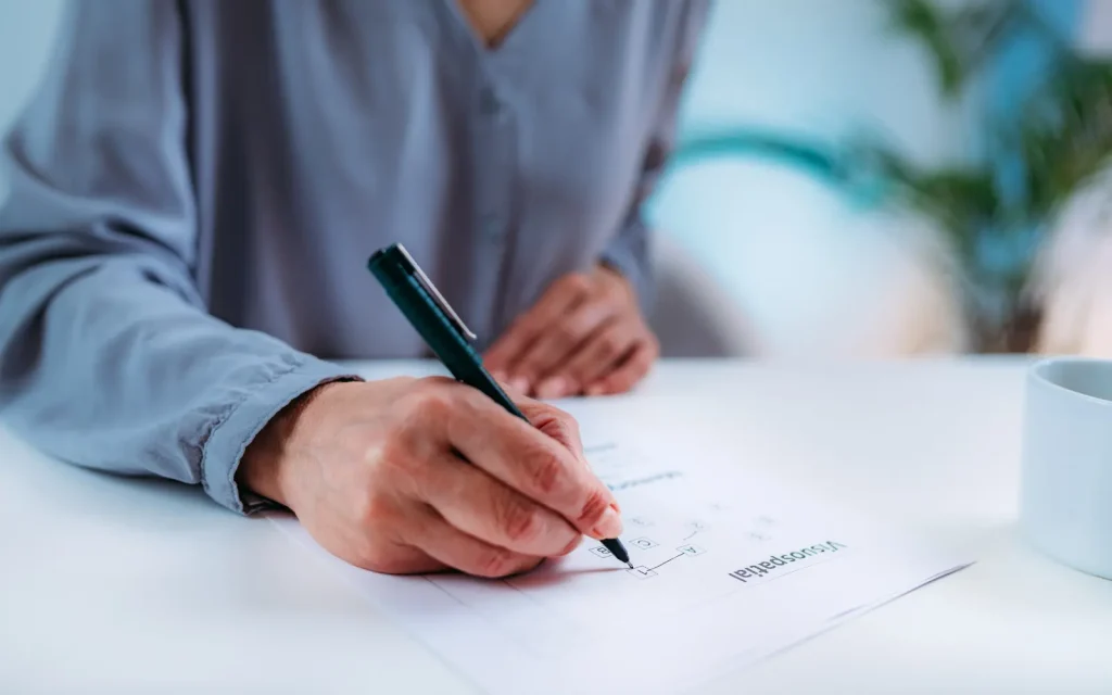 A woman taking a written assessment during her neuropsychological testing appointment