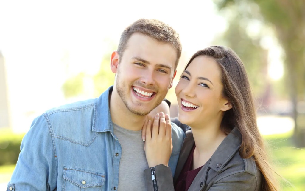 A smiling happy couple after couples therapy for neurodiverse folx in Los Angeles