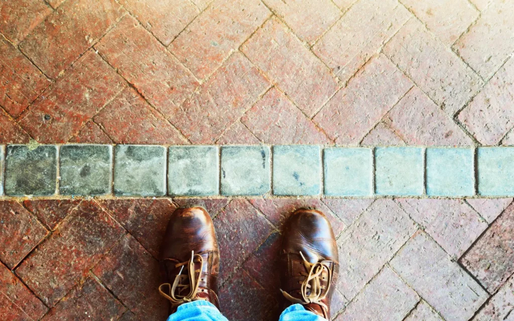 A man standing at a boundary line, representing the question "What is a boundary violation?"