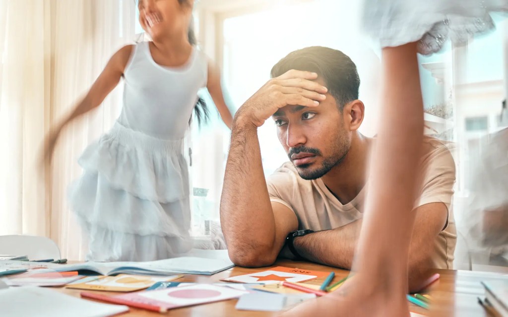 A man with ADHD appearing disinterested in his wife and daughter when actually suffering significant ADHD burnout 