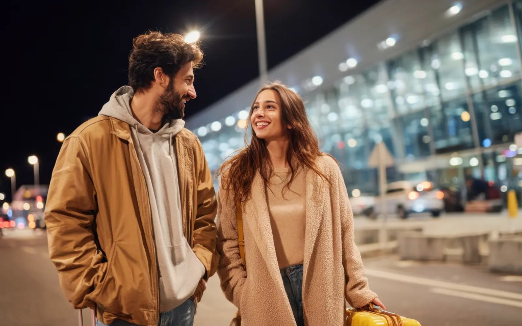 A couple walking along a street at night, representing the importance of couple goal setting in successful therapy