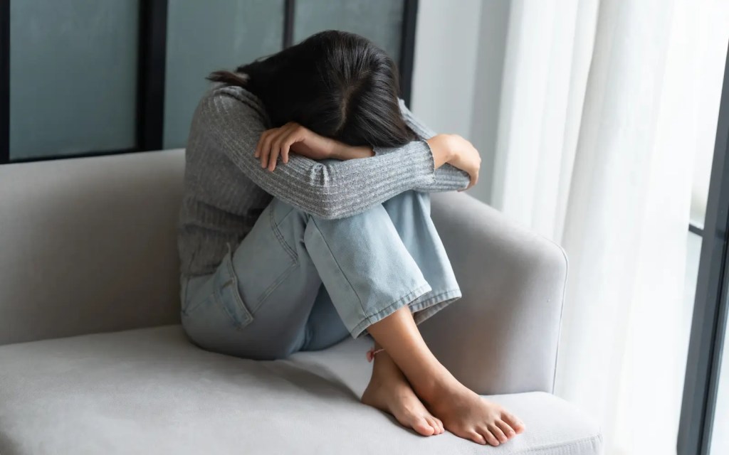 A woman in emotional paralysis, unable to communicate how she truly feels due to her ADHD symptoms