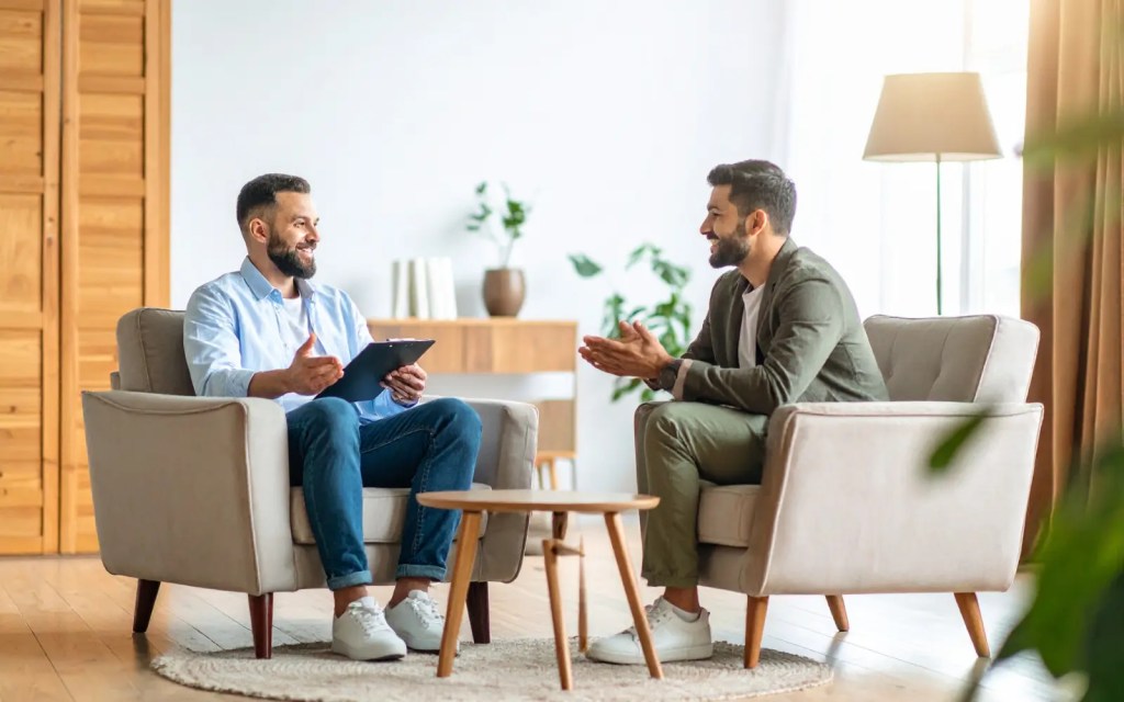 Two smiling men in a therapy session in Los Angeles